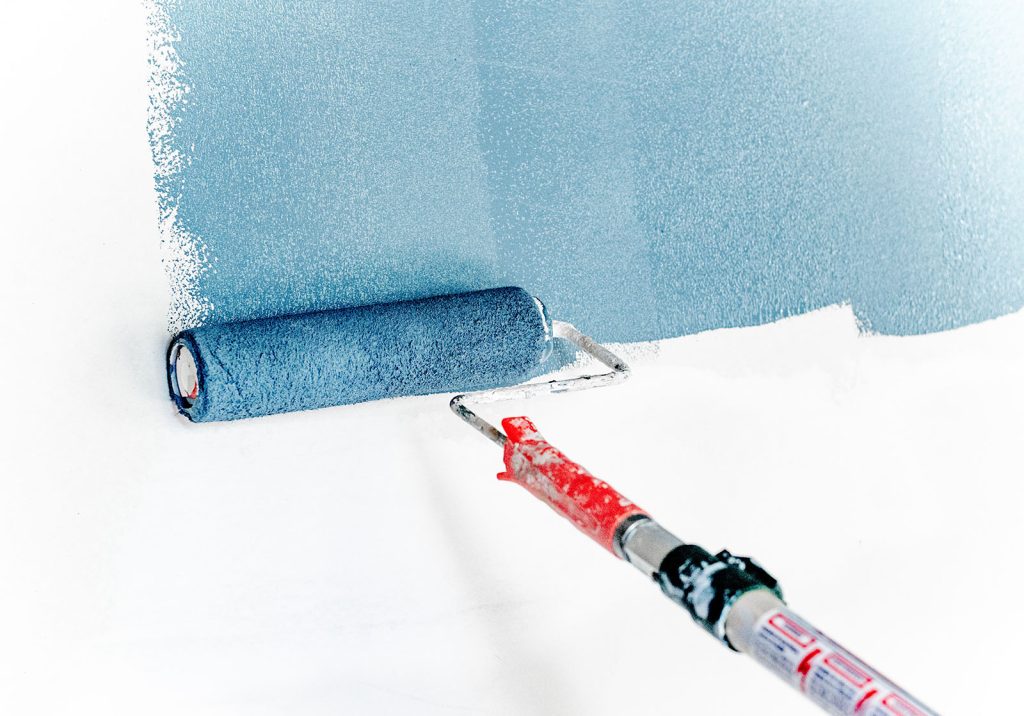 painting white wall with blue paint